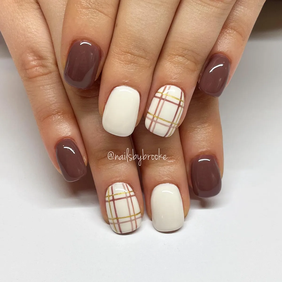 Deep mauve-brown with white and gold-lined plaid accents