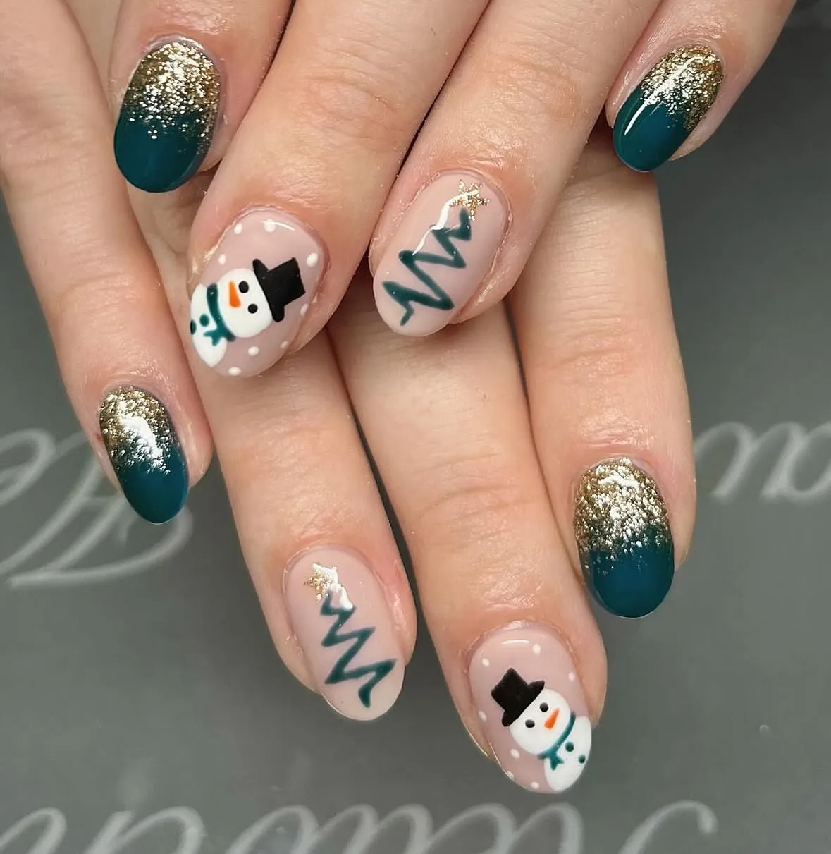 Teal and gold gradient with snowman accents