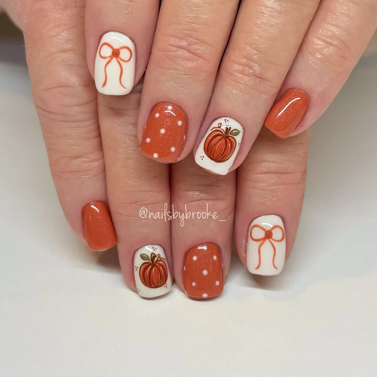 Orange and white pumpkins, bows, and polka dots