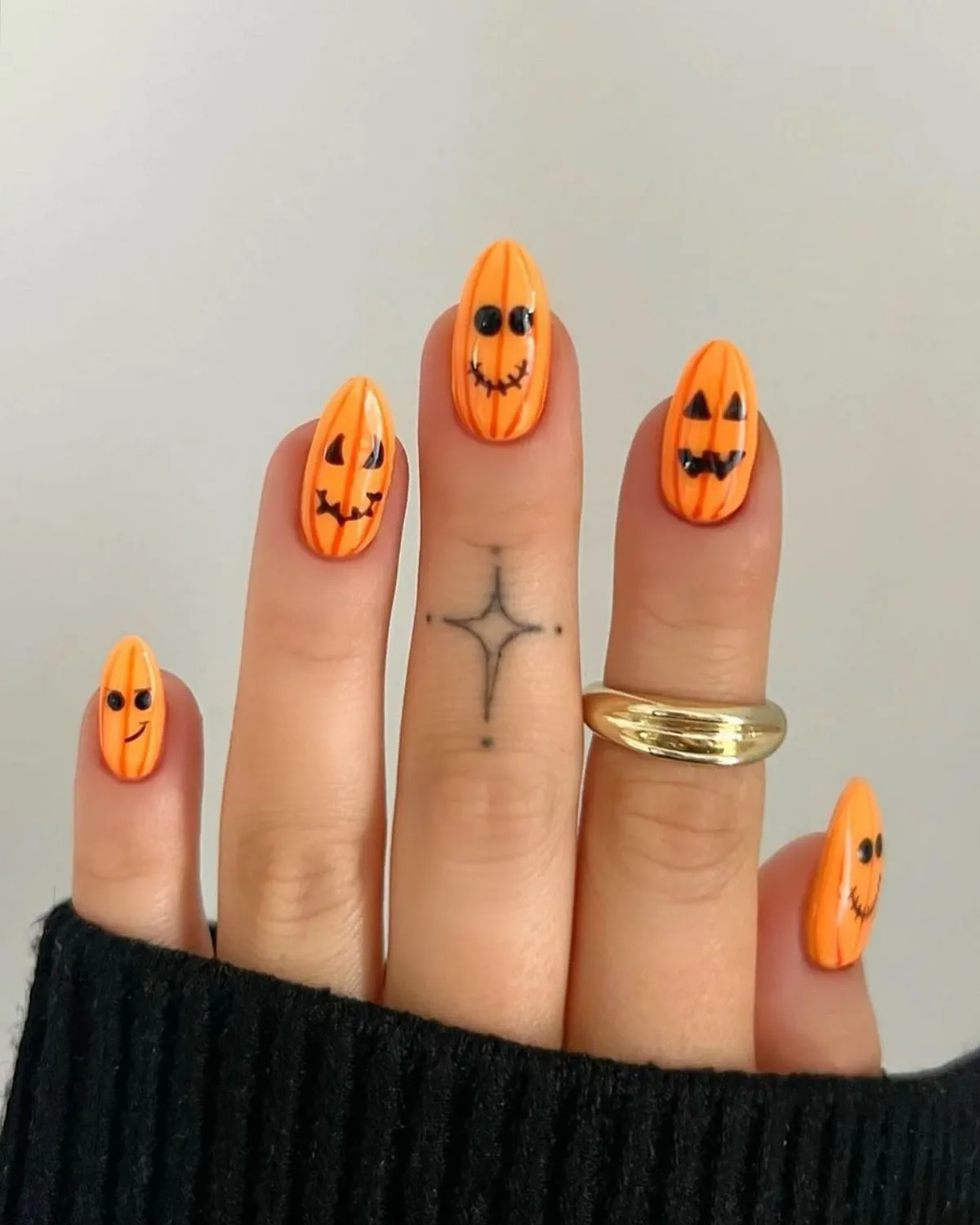 Orange character-face nails with vertical line detailing