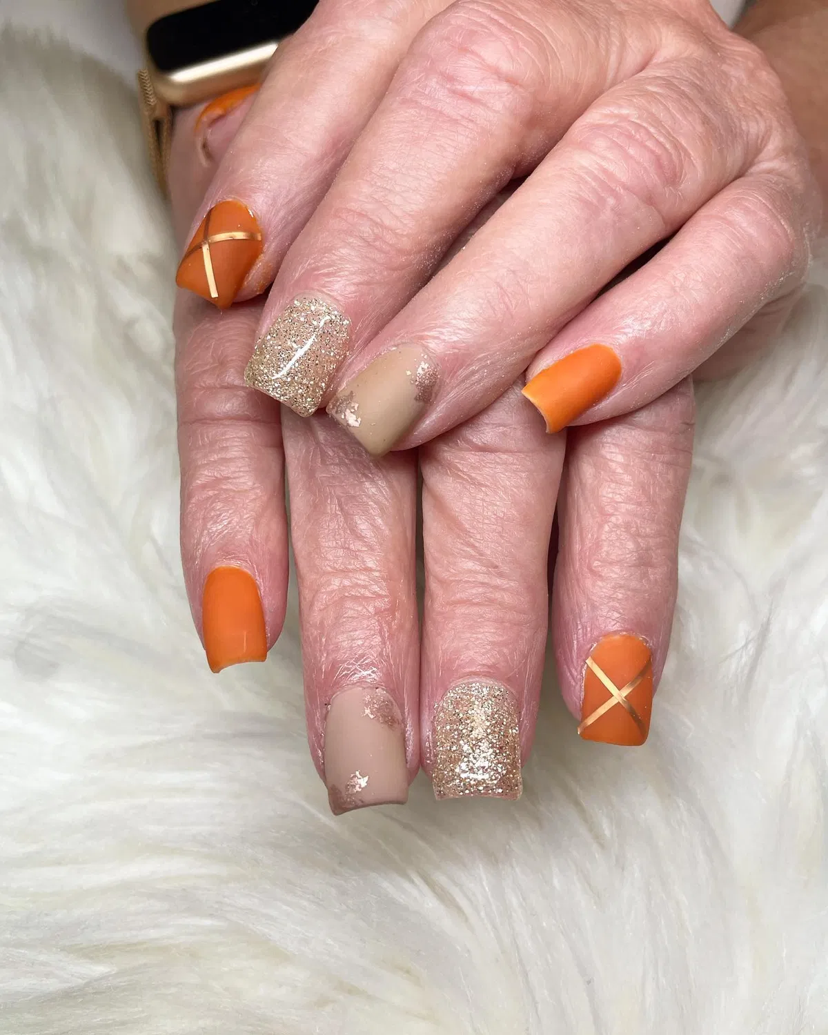 Orange with gold striping, glitter, and foil-like accents