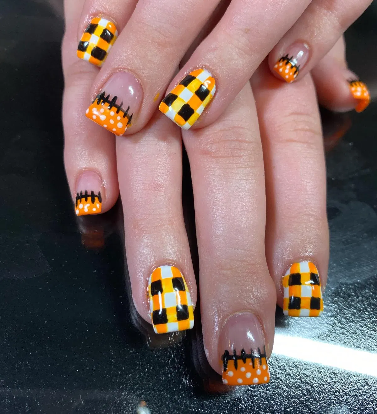 Orange checkerboard + polka-dot French tips
