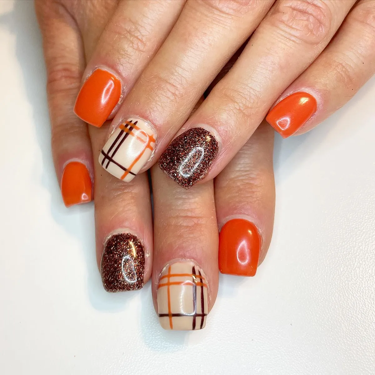 Bright orange with plaid lines and dark glitter accent