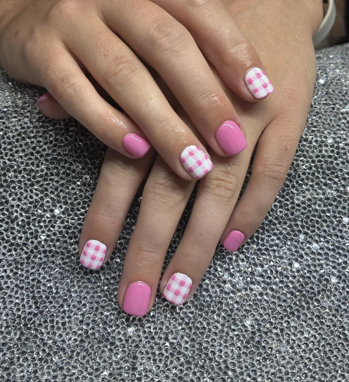 Medium pink glossy nails with gingham accents