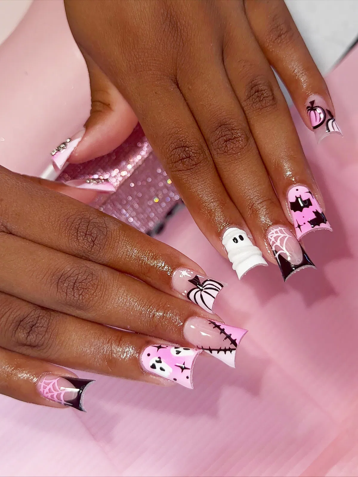 Long pink square nails with bats, web tip, and 3D ghost