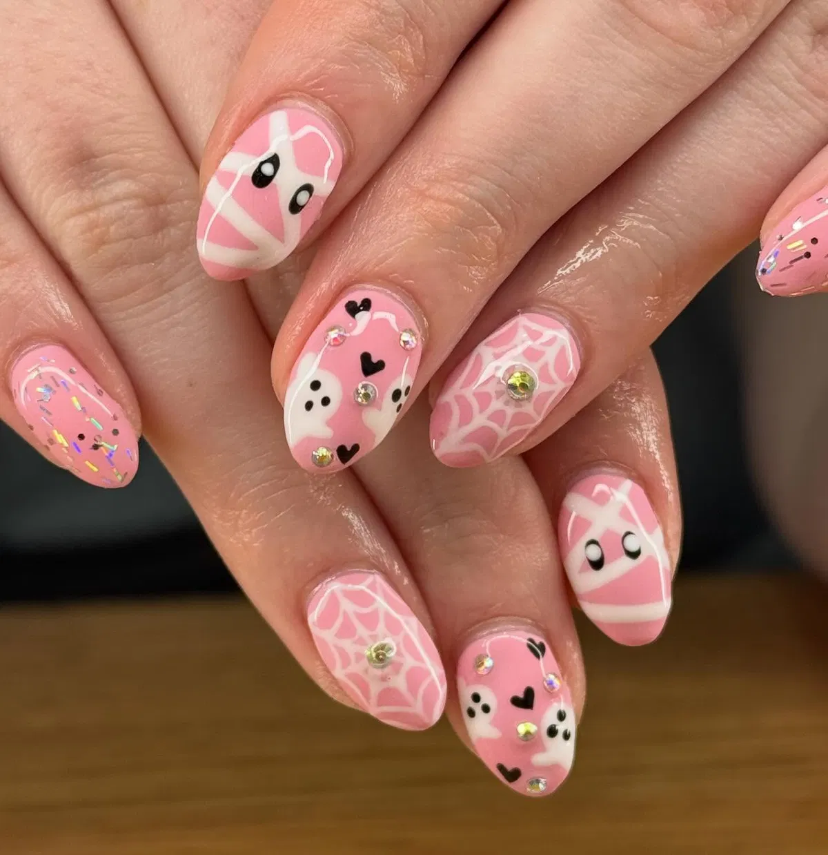 Pink-and-white mummy wraps with gems and web accents