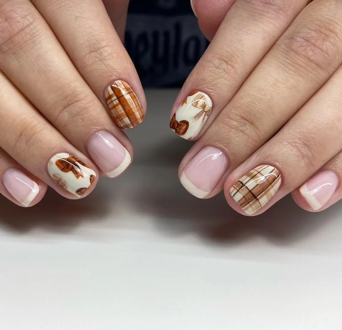 Brown plaid accents with classic off-white French tips