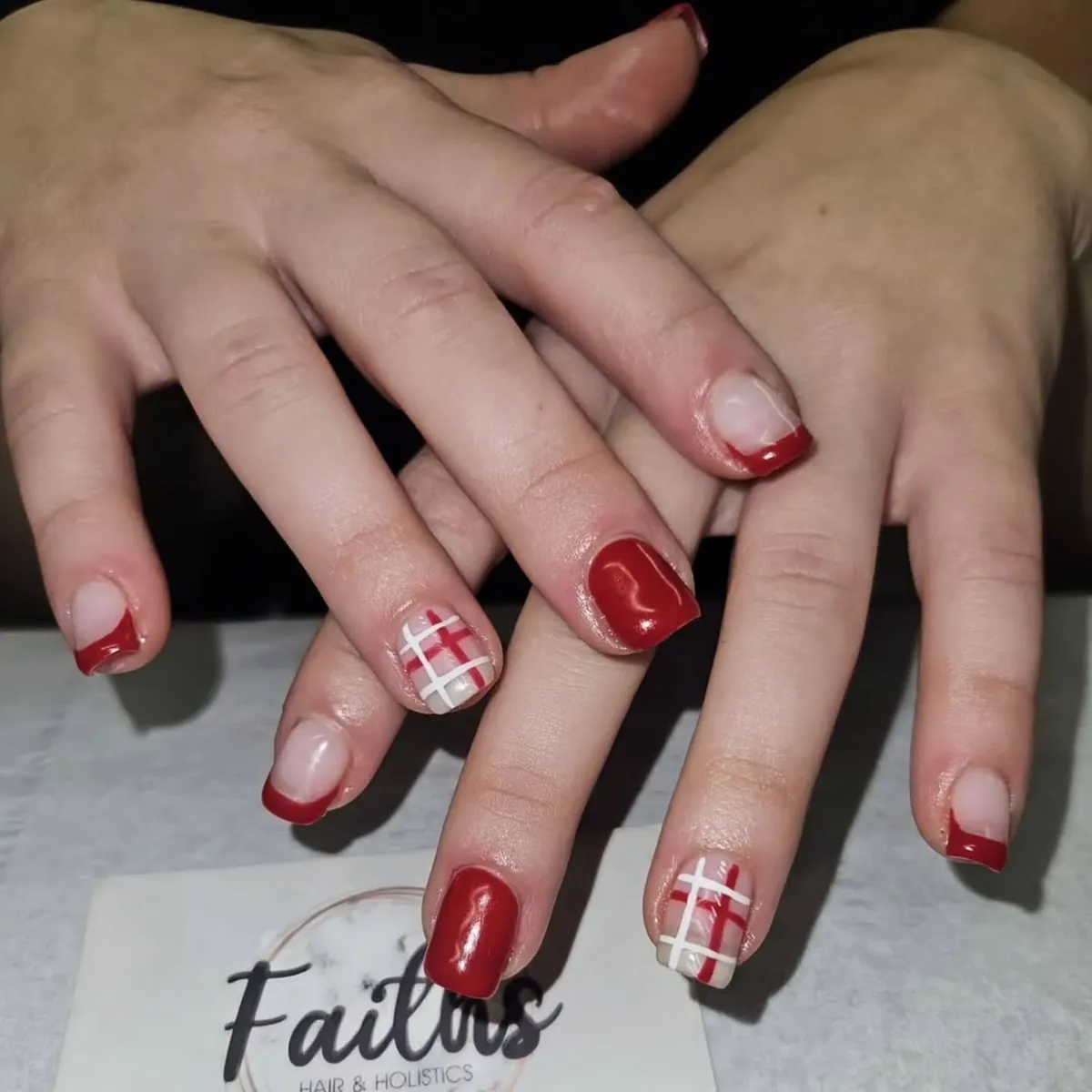 Red French tips with red-and-white plaid accent nails