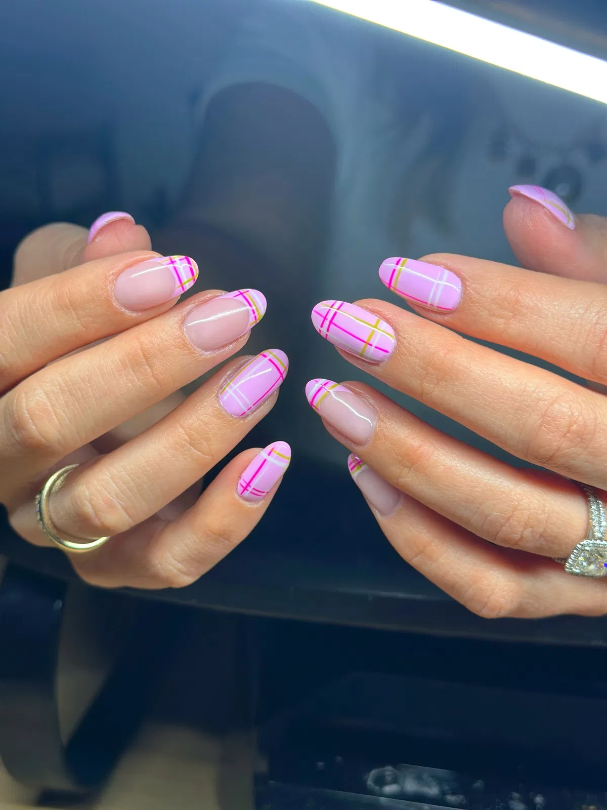 Bright pink plaid lines with yellow accents on pale pink nails