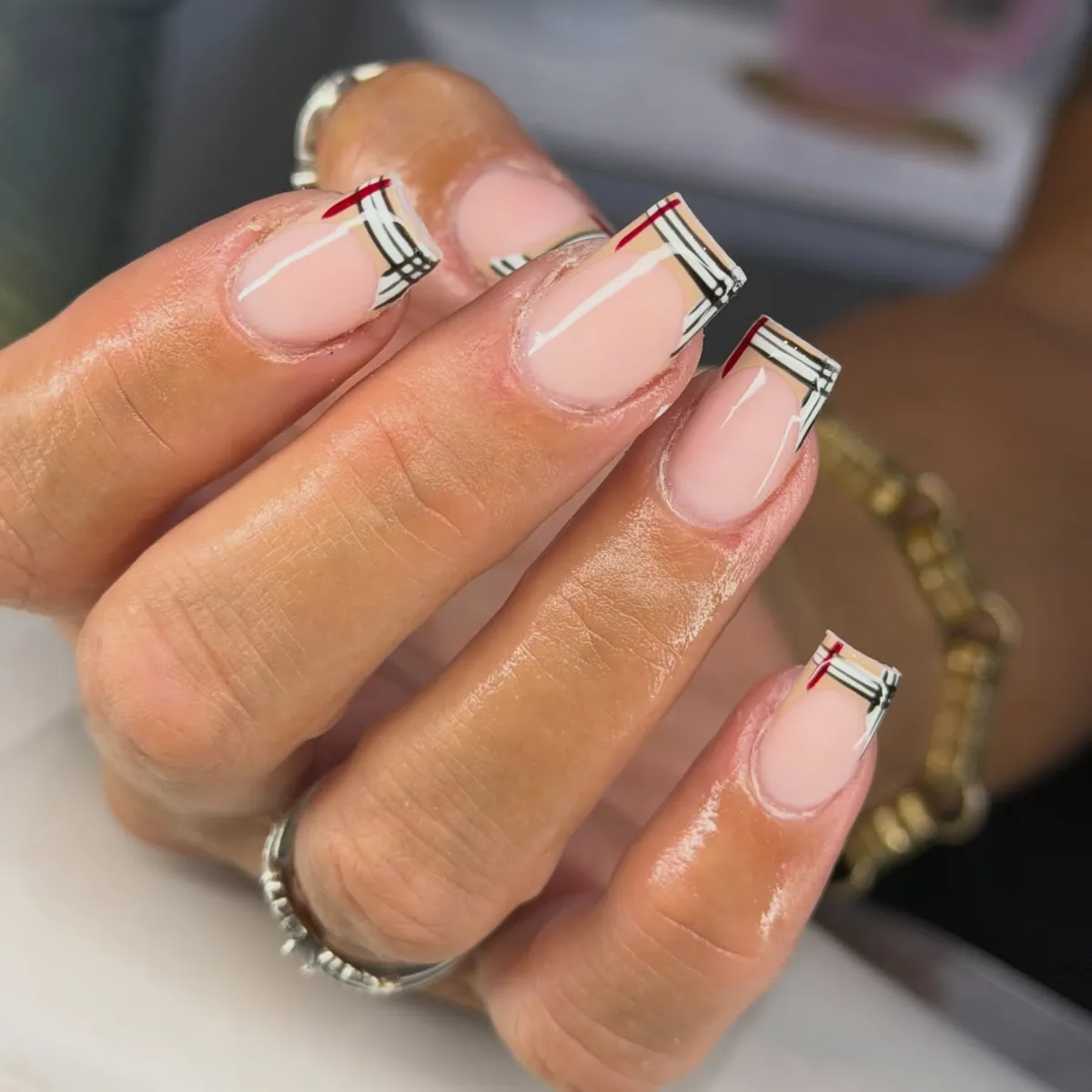 Corner plaid French tips with black, white, and red lines
