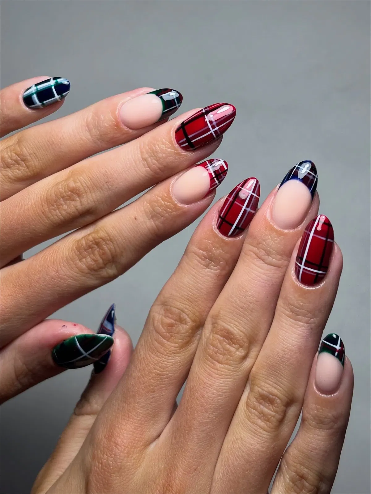 Red plaid full-coverage nails with dark plaid tip accents