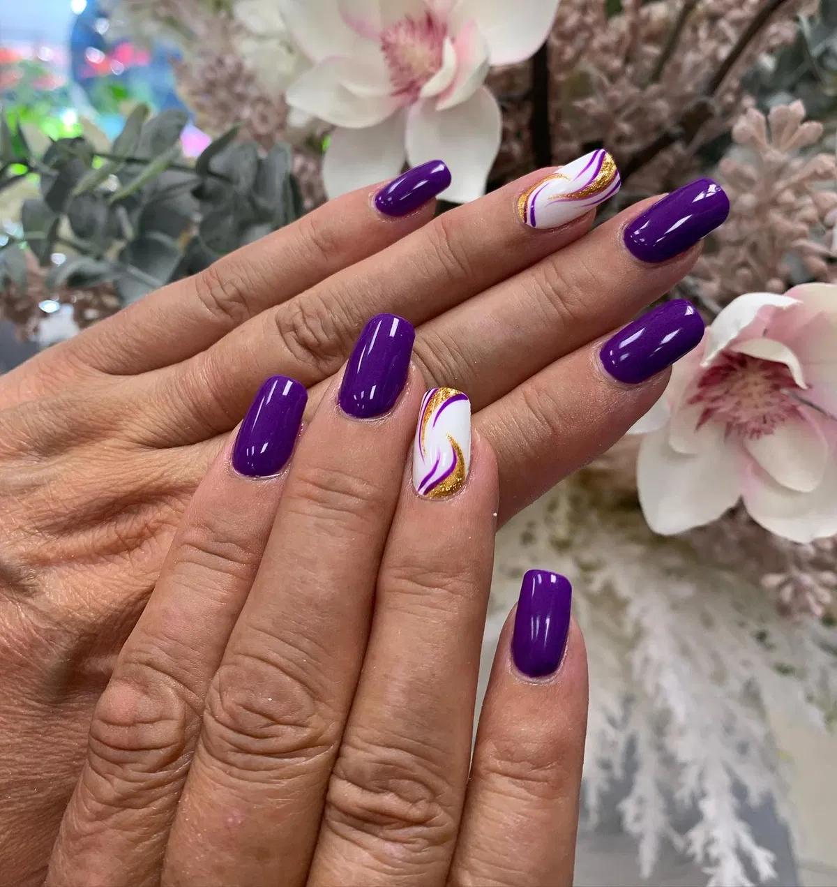 Deep purple gloss with white-and-gold swirl accents