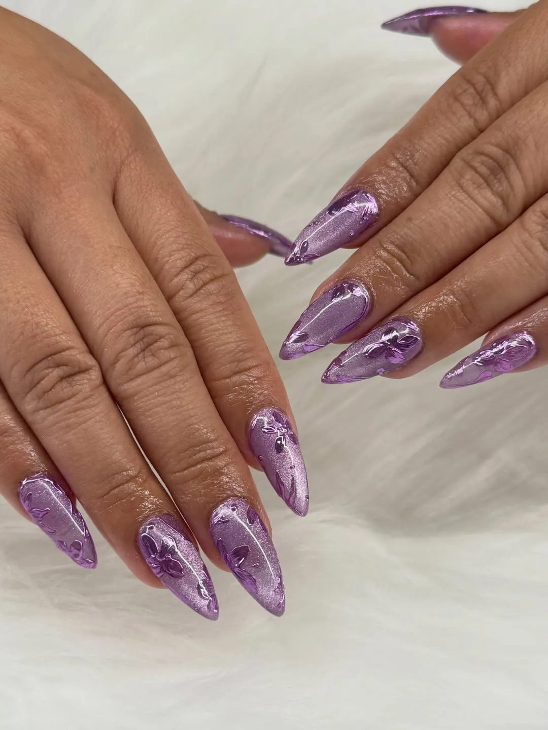 Metallic lavender stiletto nails with embossed floral details