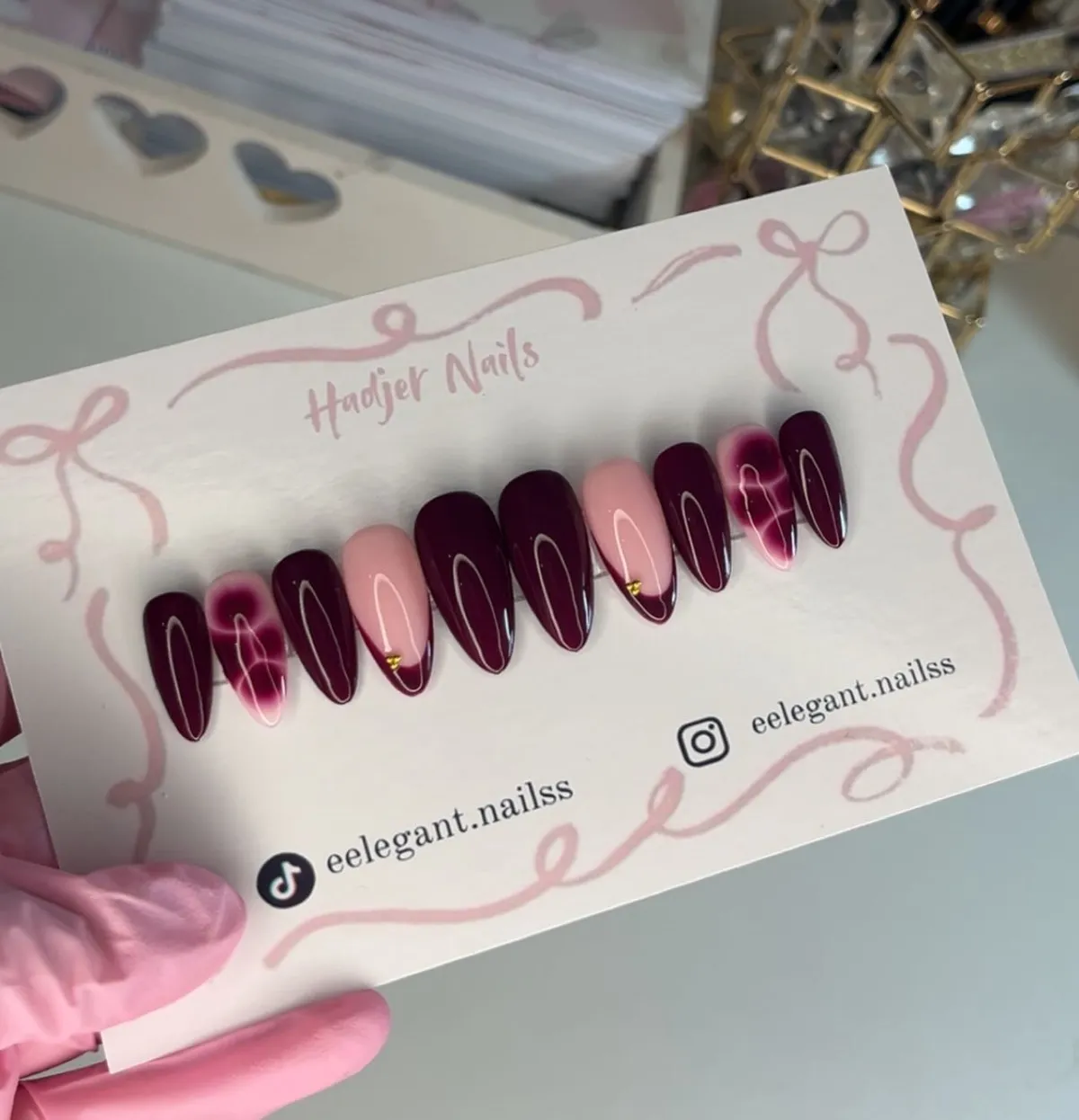Deep plum set with nude French tips and marbled accents (display card)