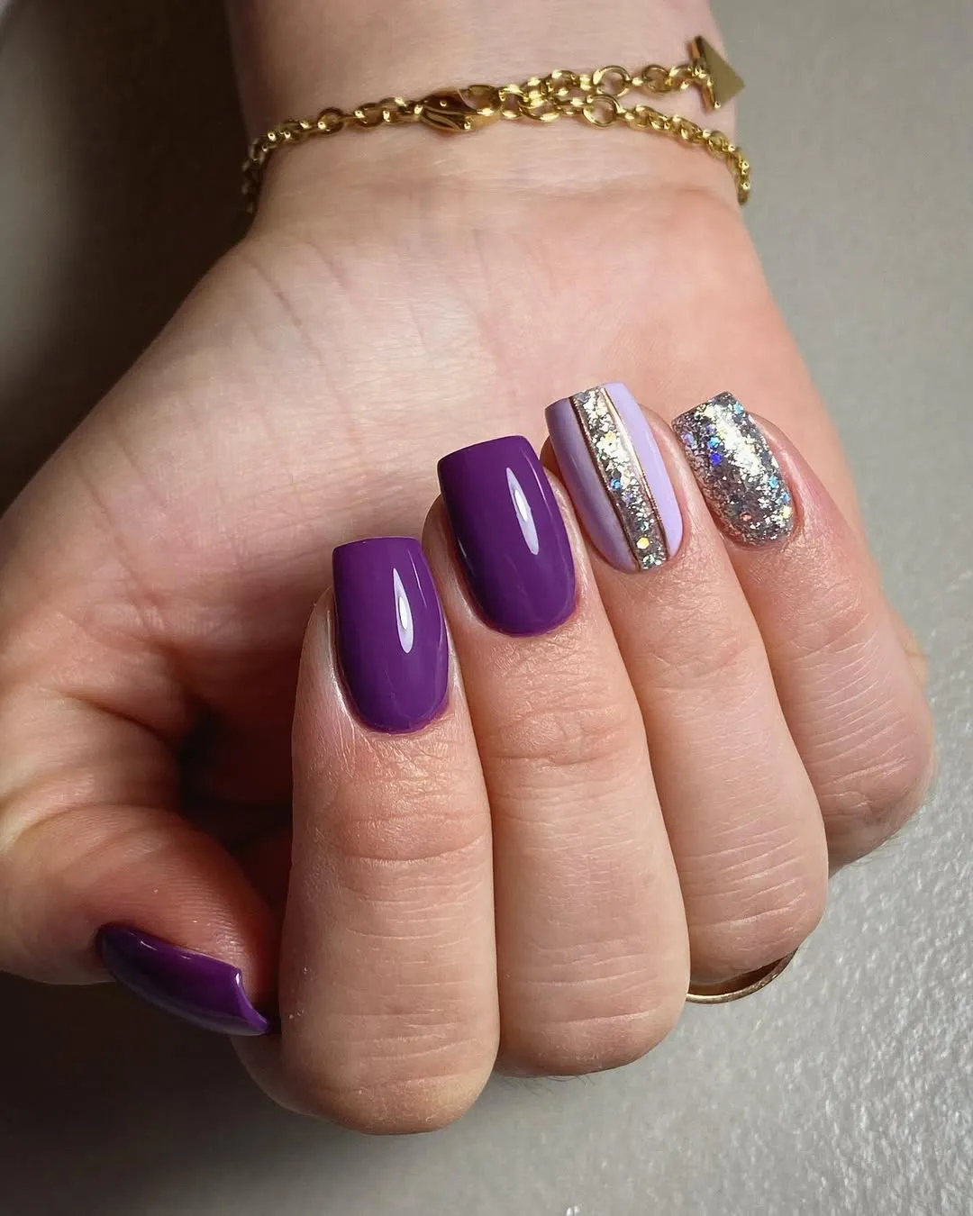 Glossy purple squares with silver glitter stripe and full glitter nail