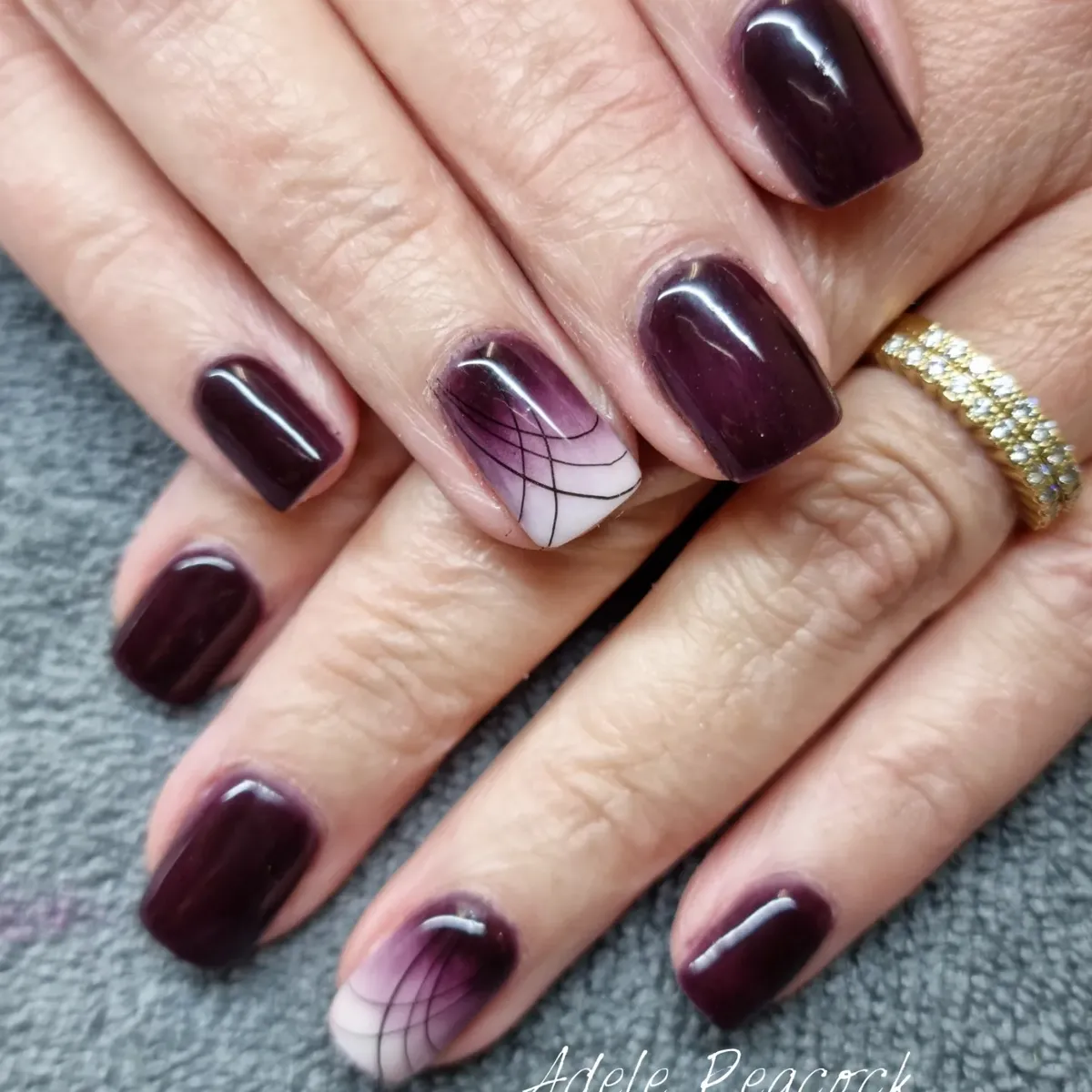 Dark plum gloss with curved linework accent