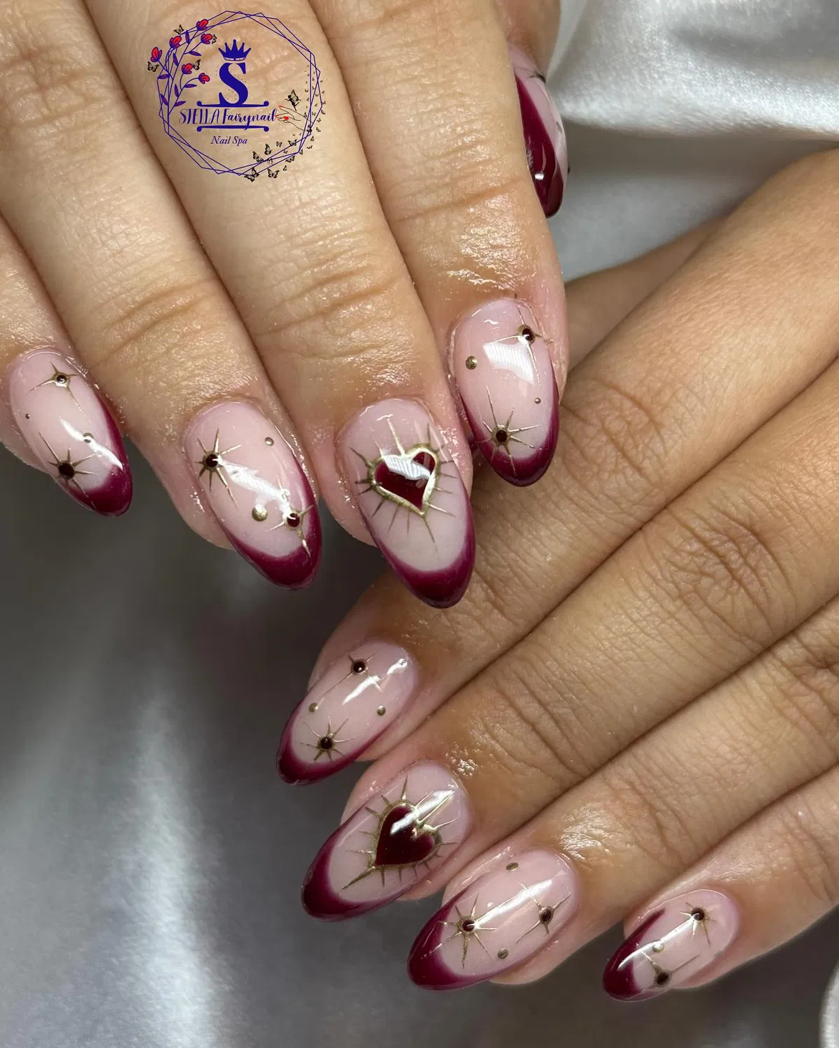 Pink-and-plum French tips with gold hearts and studs
