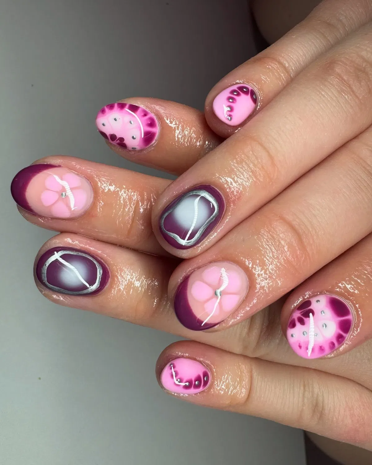 Pink-and-plum mixed art with outlined centers and studs