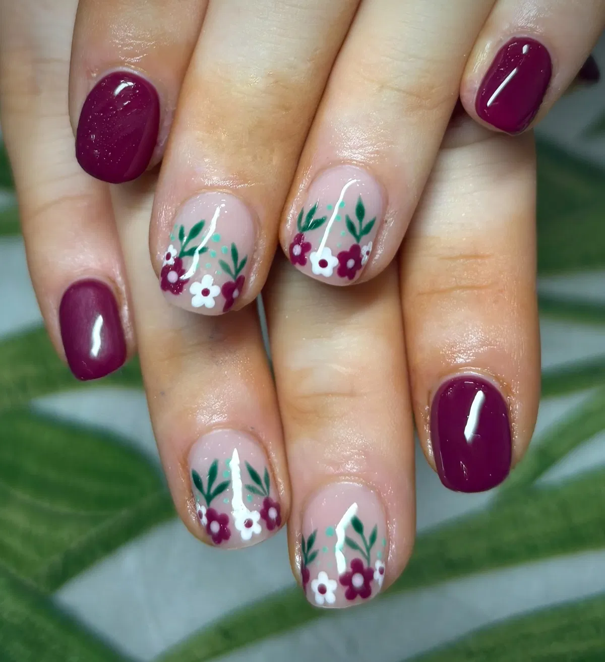 Plum solids with nude floral nail art