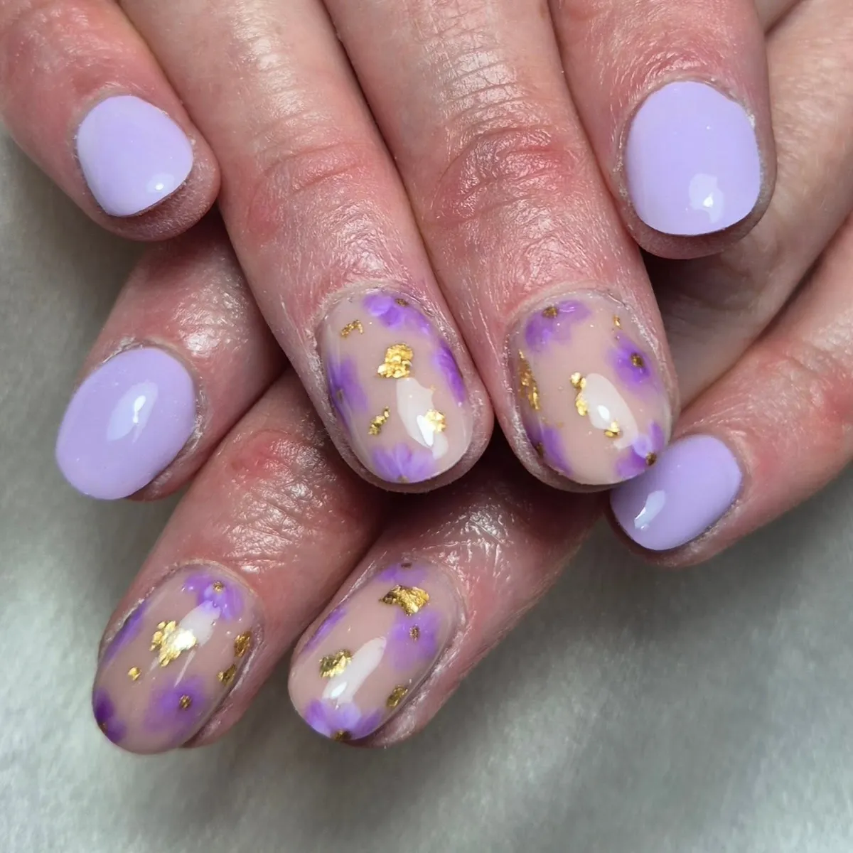 Soft lilac solids with nude-and-purple accents and gold flakes