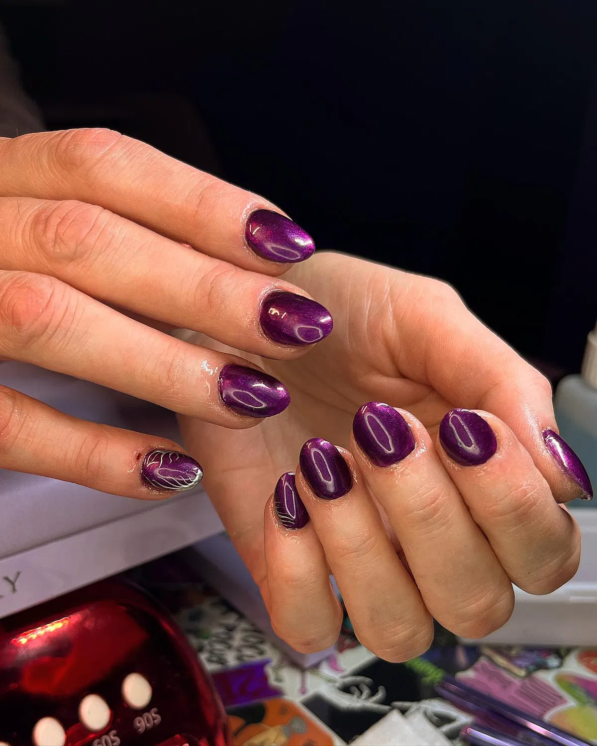 Deep plum reflective finish with white leaf-line accents