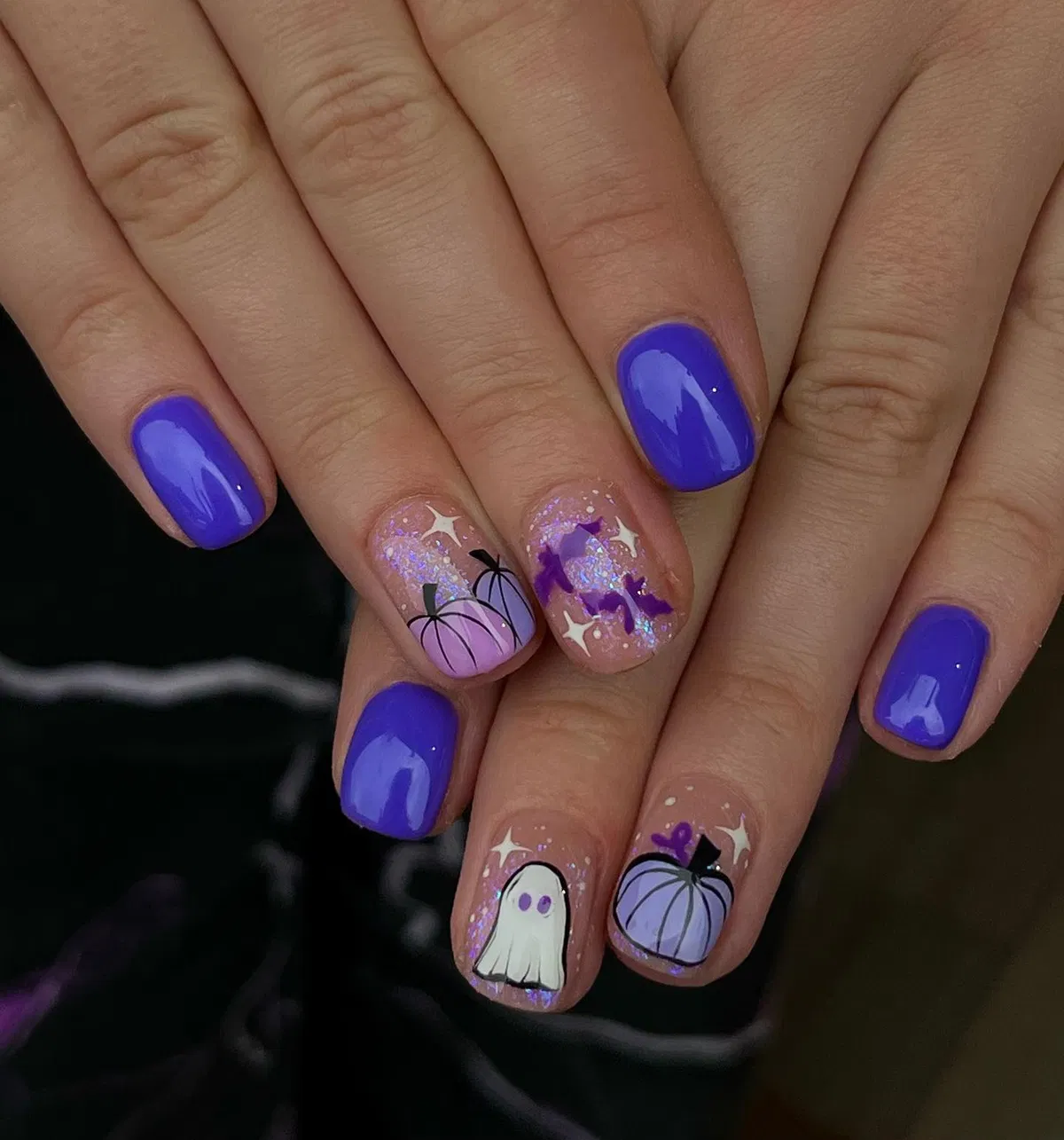 Purple solids with glittery nude accents featuring pumpkins, bats, and a ghost