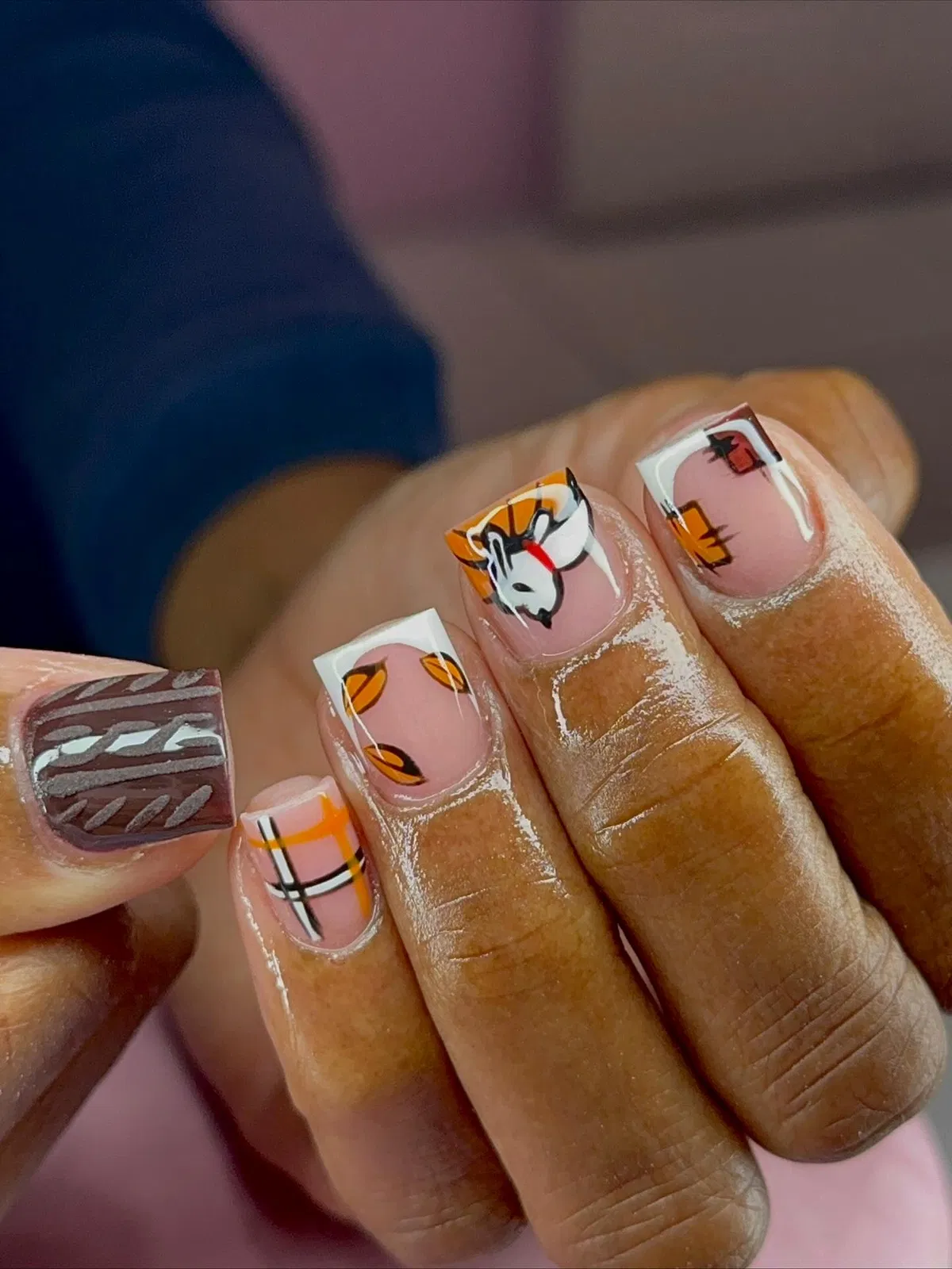 French tips with mixed plaid, leaf, and animal-face art