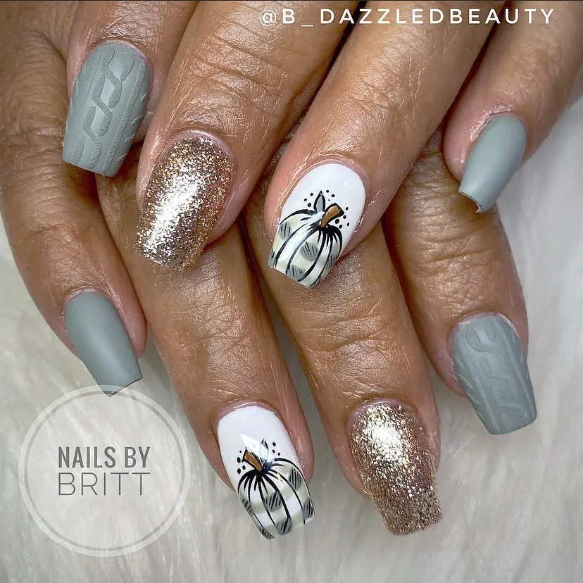 Matte gray textured nails with gold glitter and pumpkin art