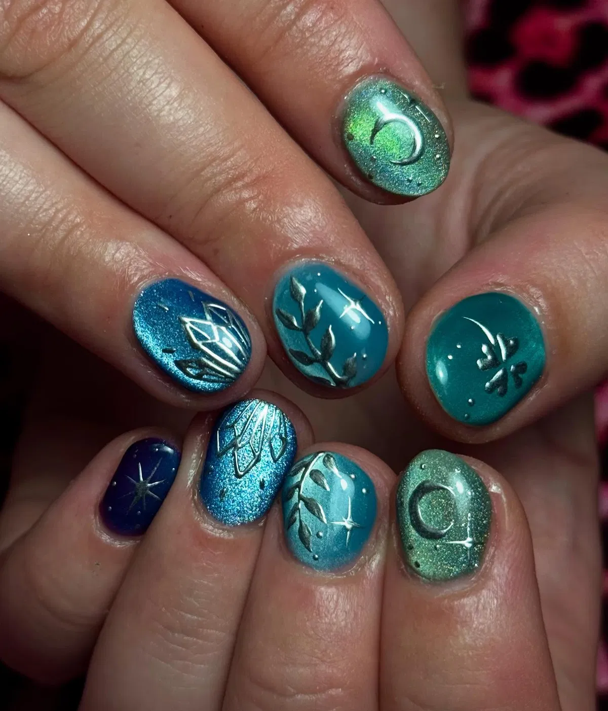 Teal-to-blue shimmer with silver raised-style motifs