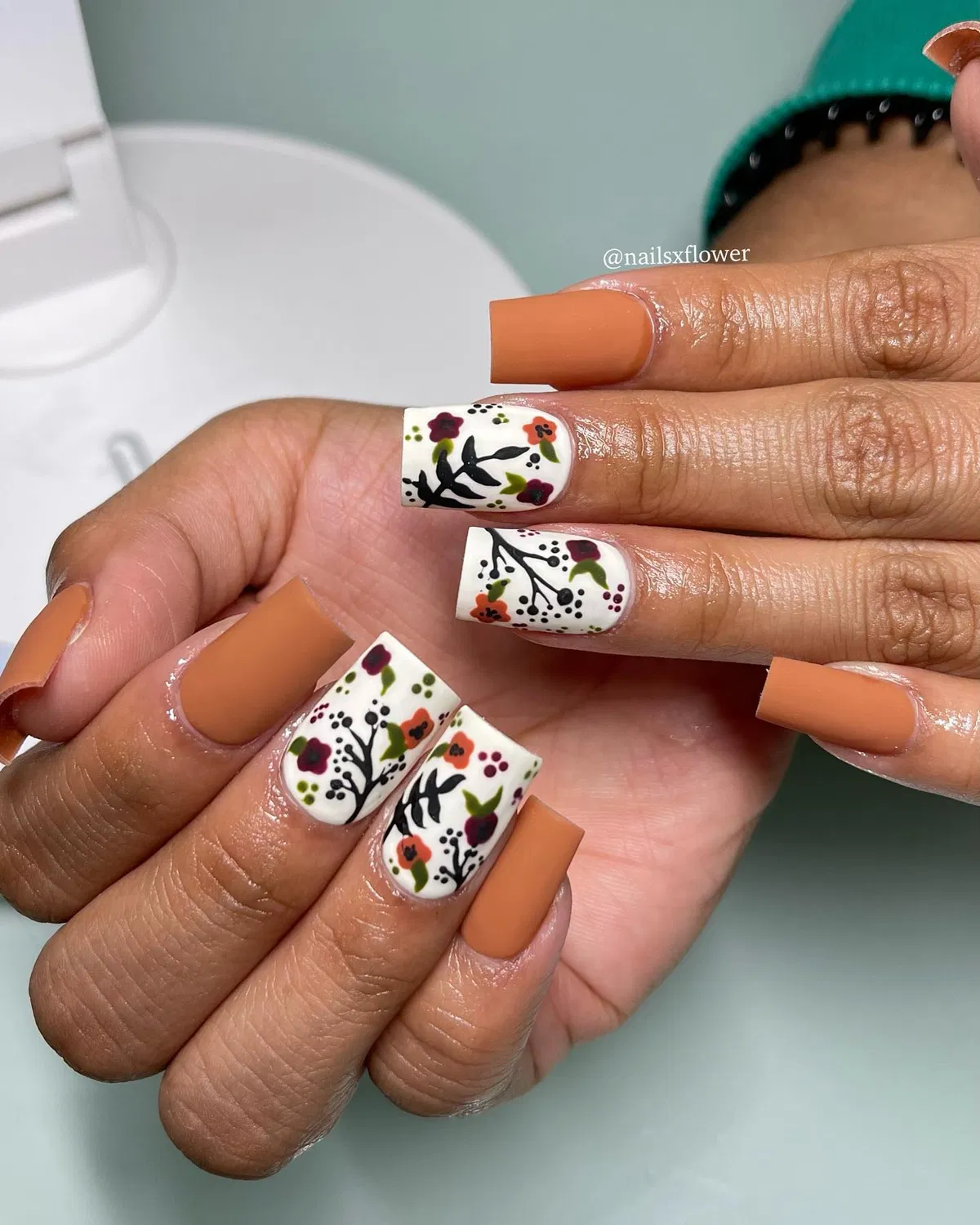 Matte tan/orange with white floral accent nails