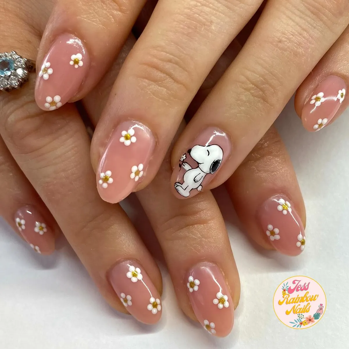 Sheer pink daisies with a cartoon dog accent nail