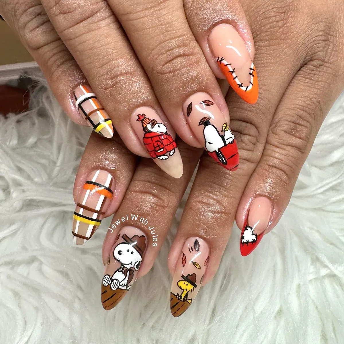 Plaid accents and warm-toned cartoon character nail art