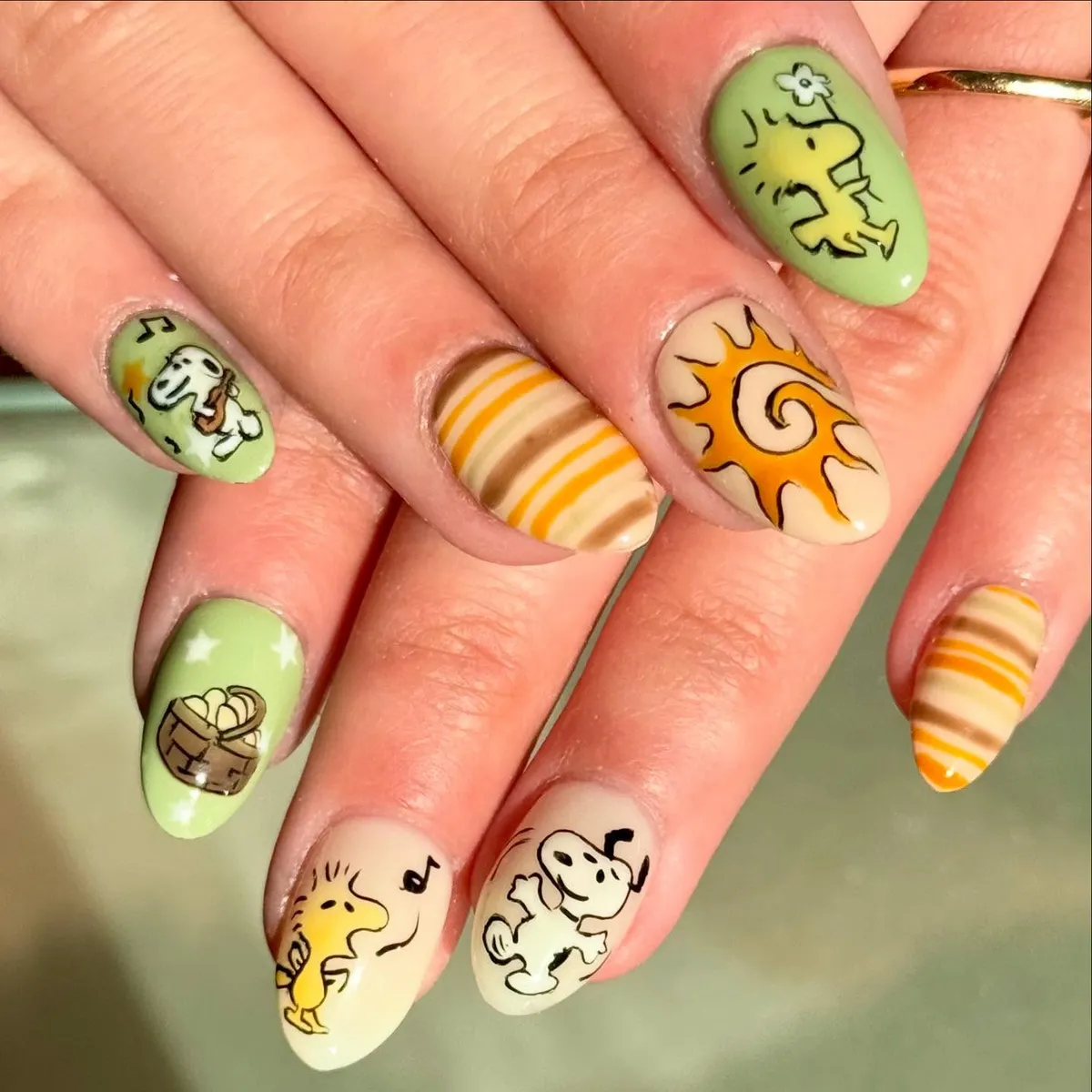 Green and cream set with stripes, spiral sun, and cartoon art