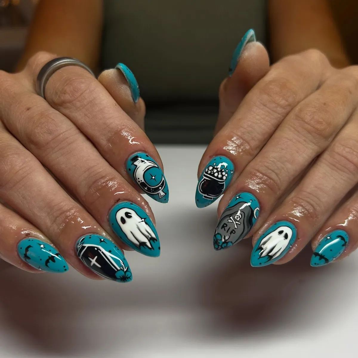 Teal spooky icons with ghosts and βRIPβ tombstone