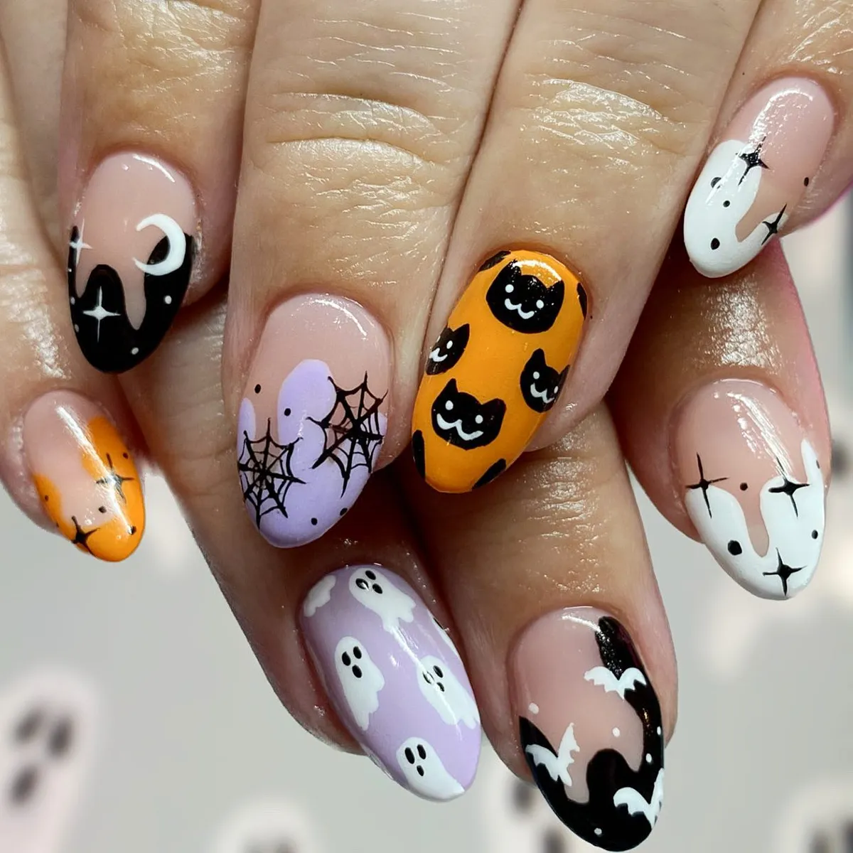 Classic Halloween icons in orange, lavender, black, and nude