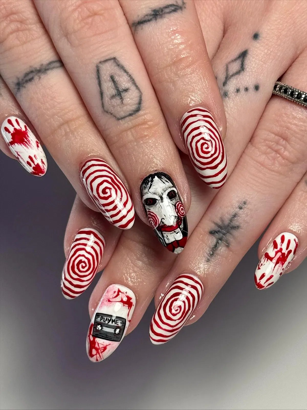 Red spirals, handprints, and illustrated face with βPLAY MEβ tape