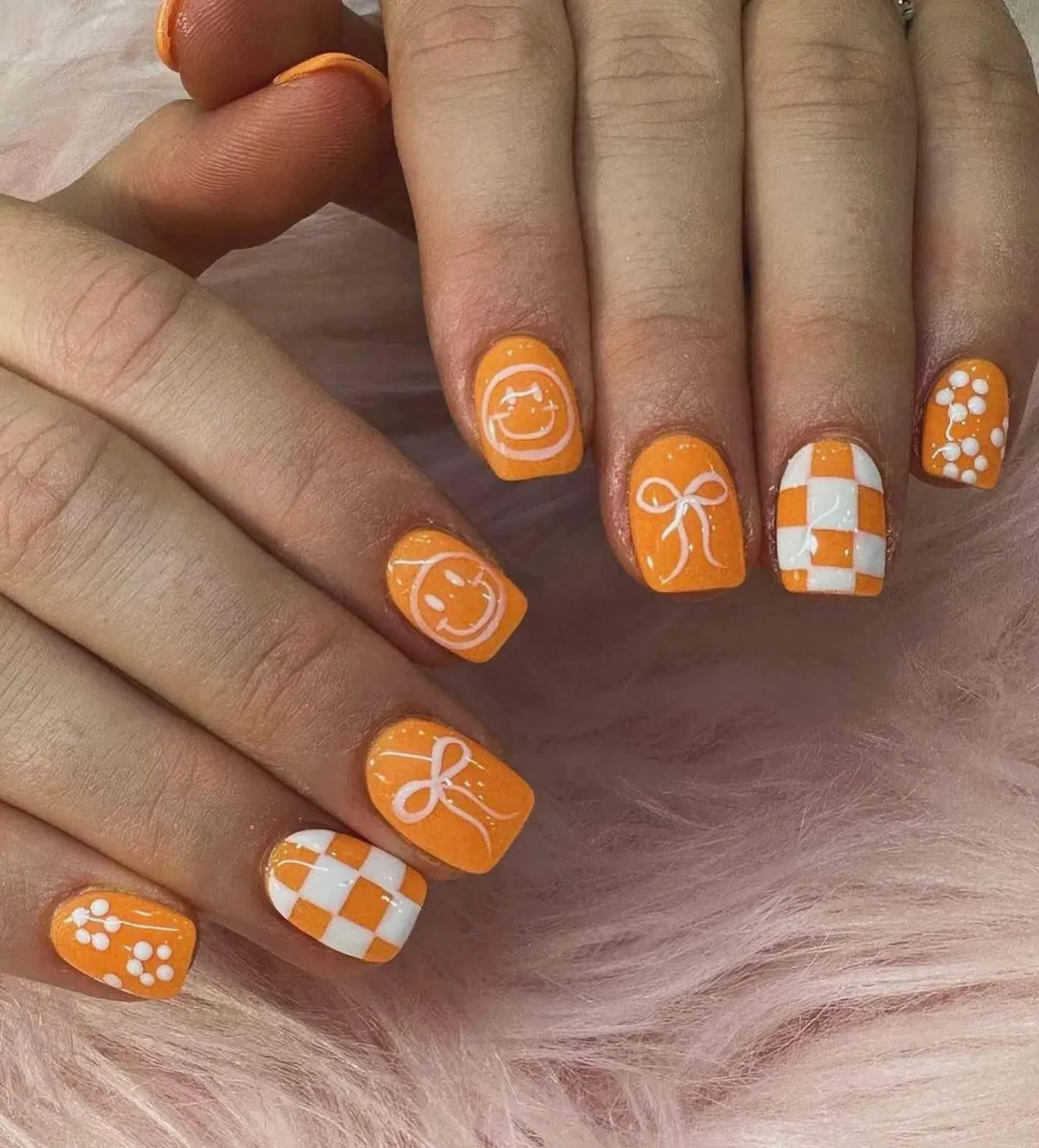 Orange graphic line art with checkerboard and dot clusters