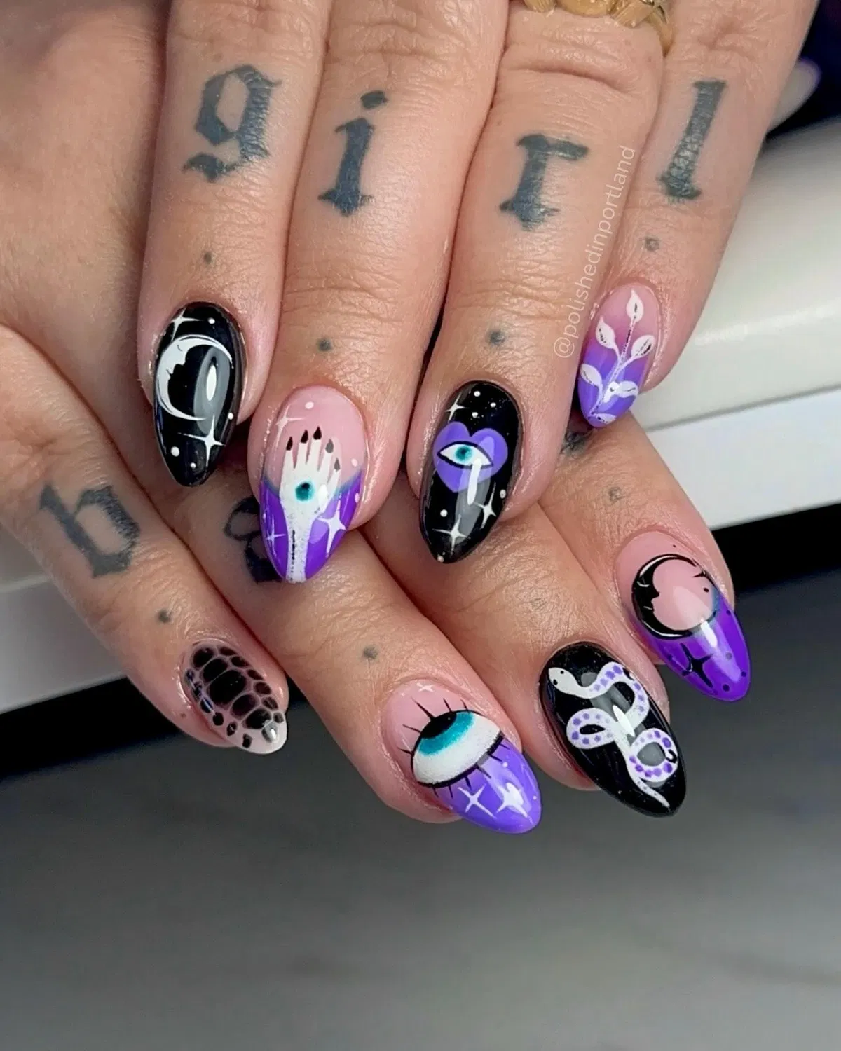 Purple-and-black mix with eye, moon, snake, and spot accents