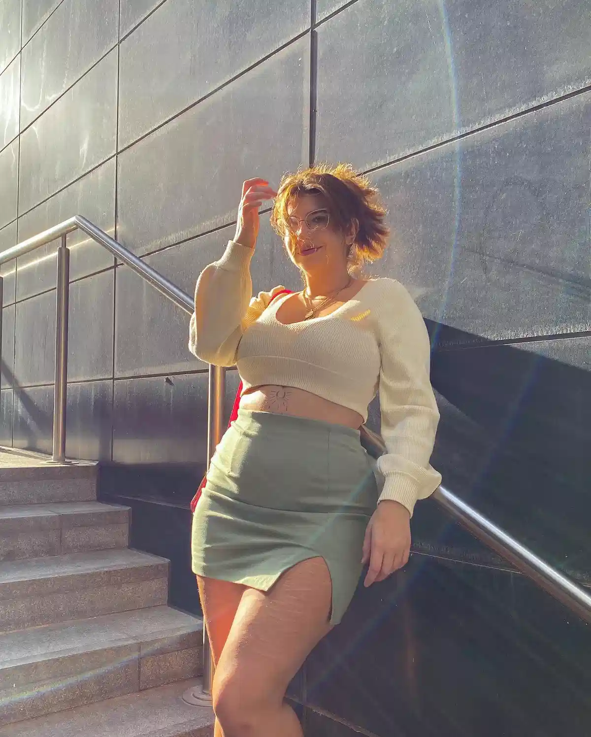 Cream cropped sweater with green slit mini skirt