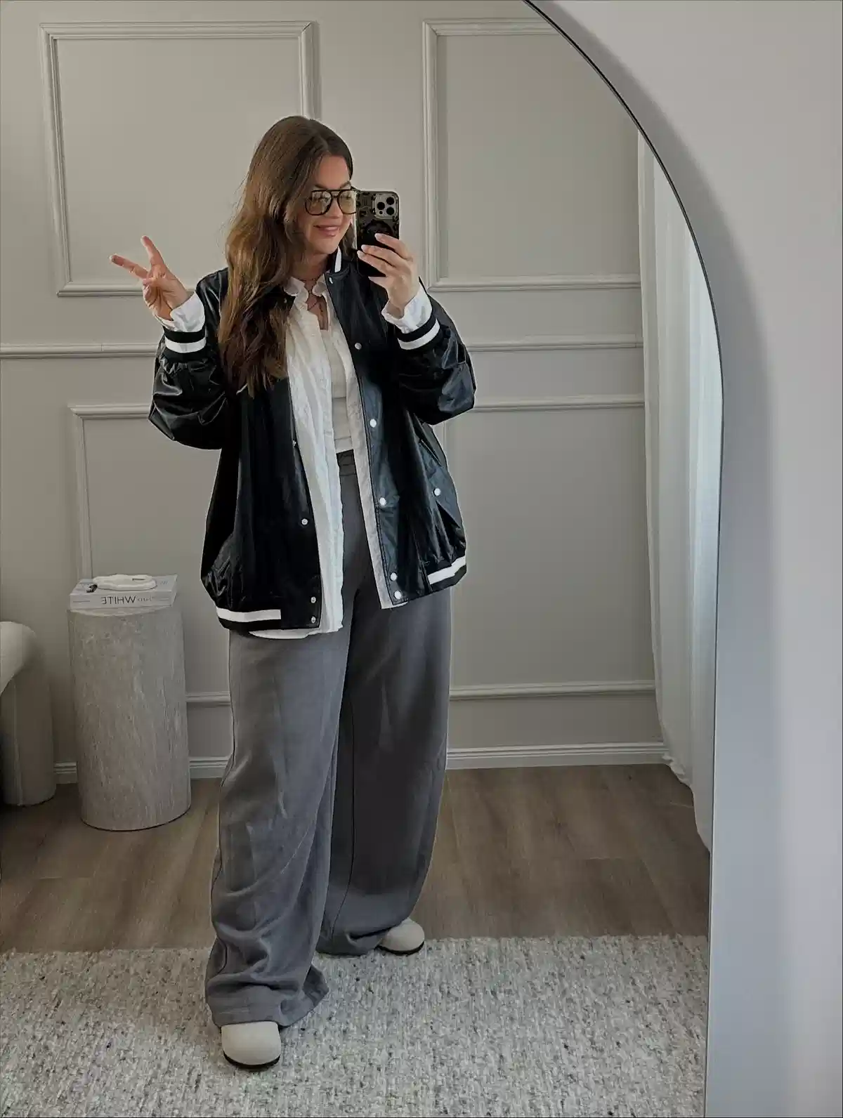Black jacket over white shirt with gray wide-leg pants