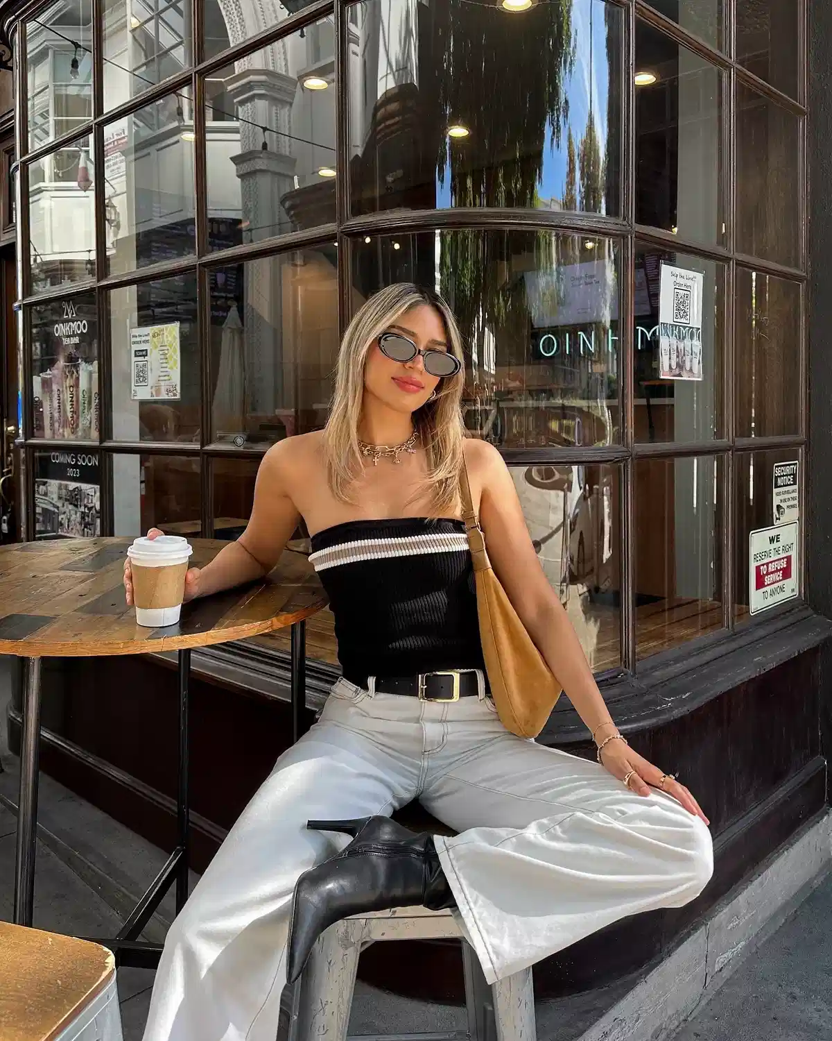 Black strapless top with light wide-leg pants and ankle boots