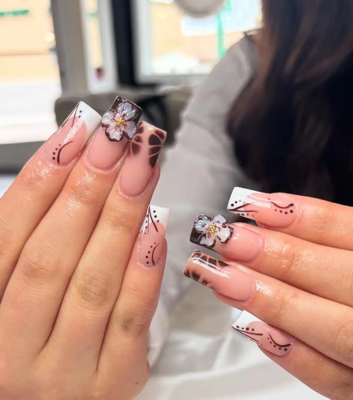 White French tips with brown linework, spots, and raised floral accents