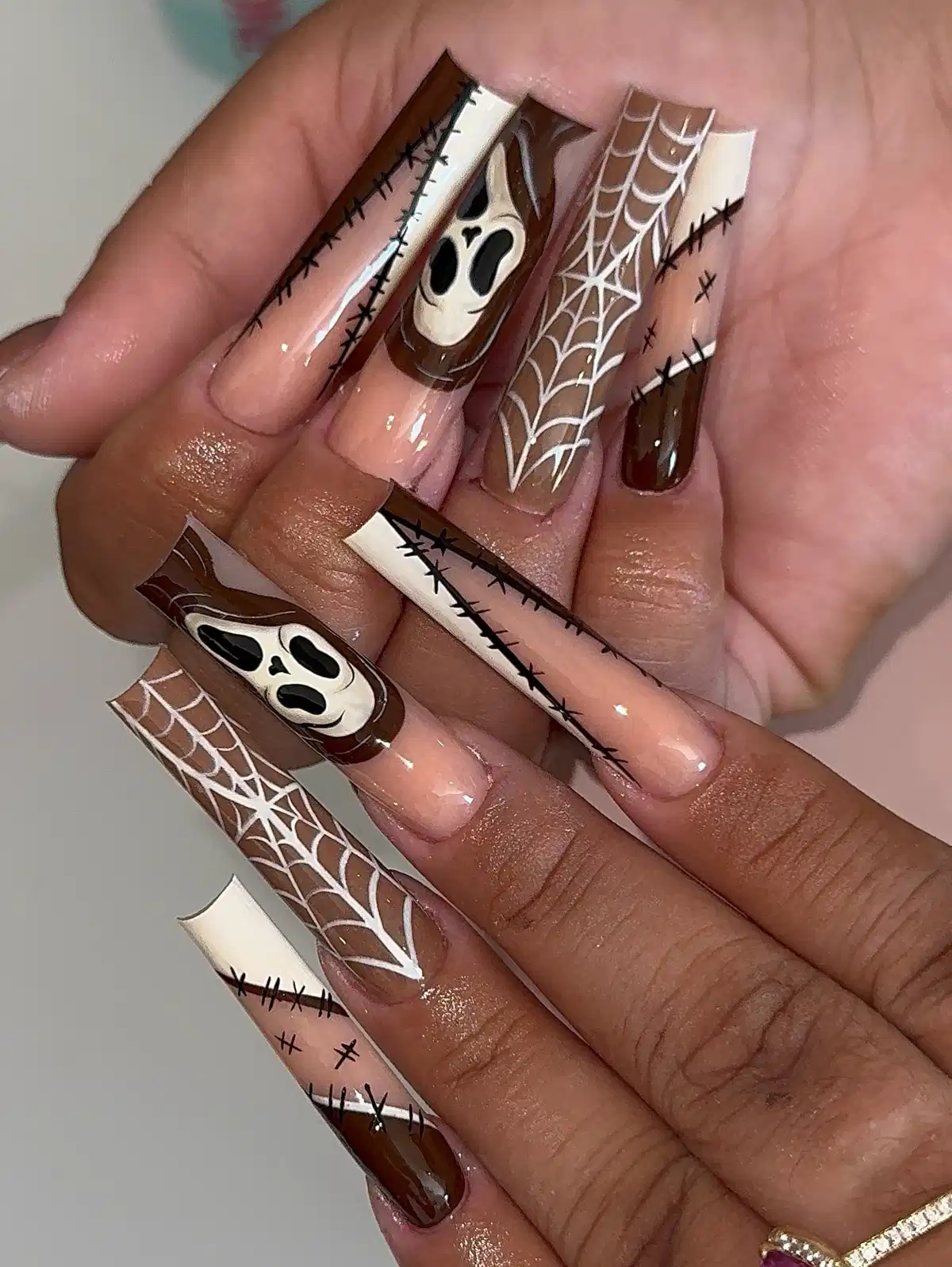 Brown-and-nude spooky set with ghost faces and web lines