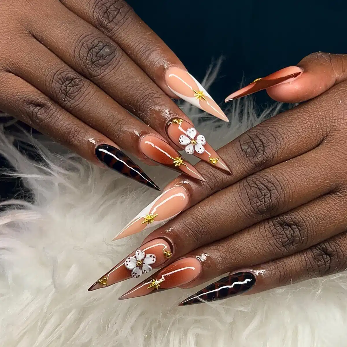 Long stiletto nude-and-brown set with gold stars and 3D flowers