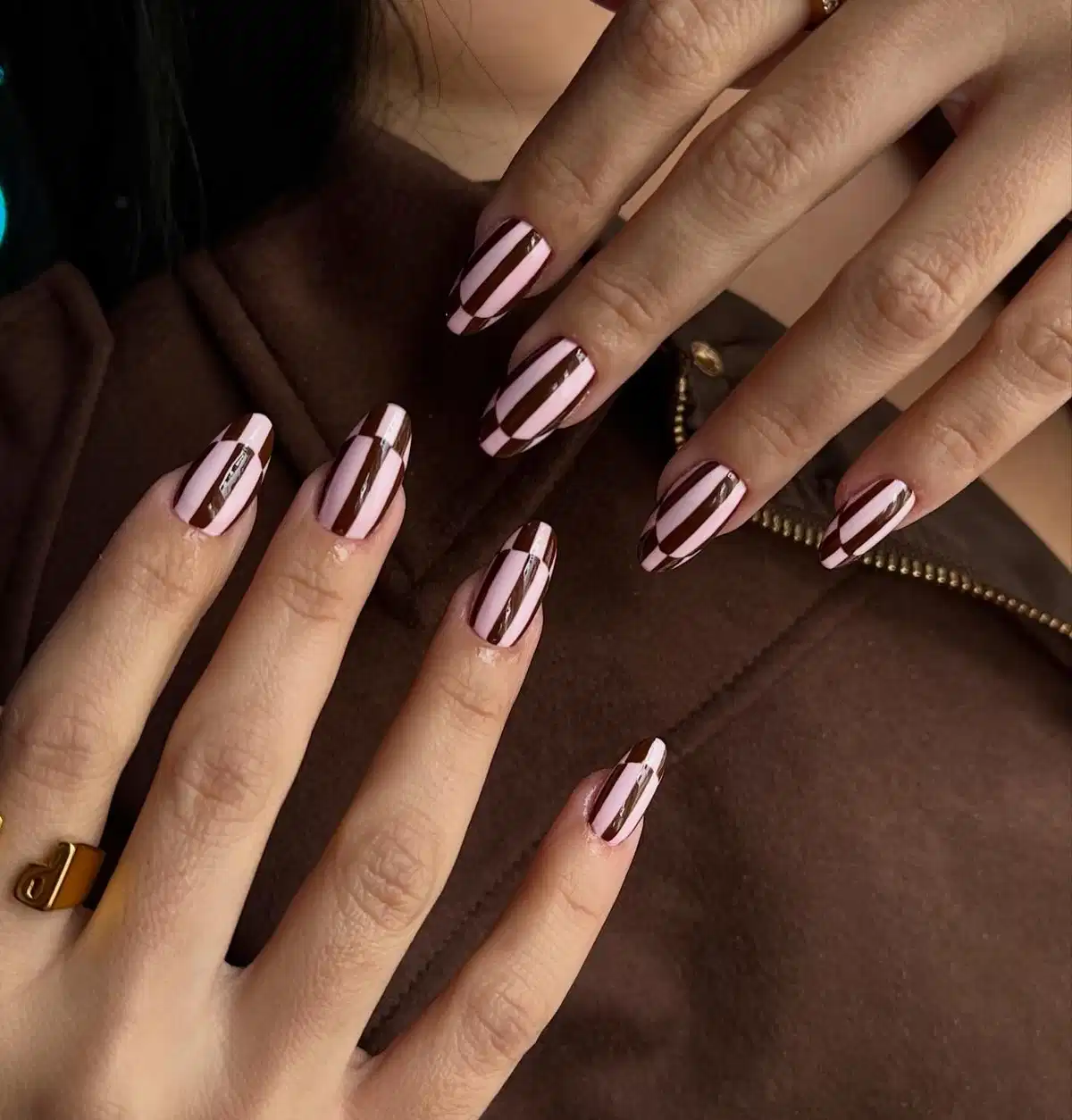 Light pink nails with vertical brown striping