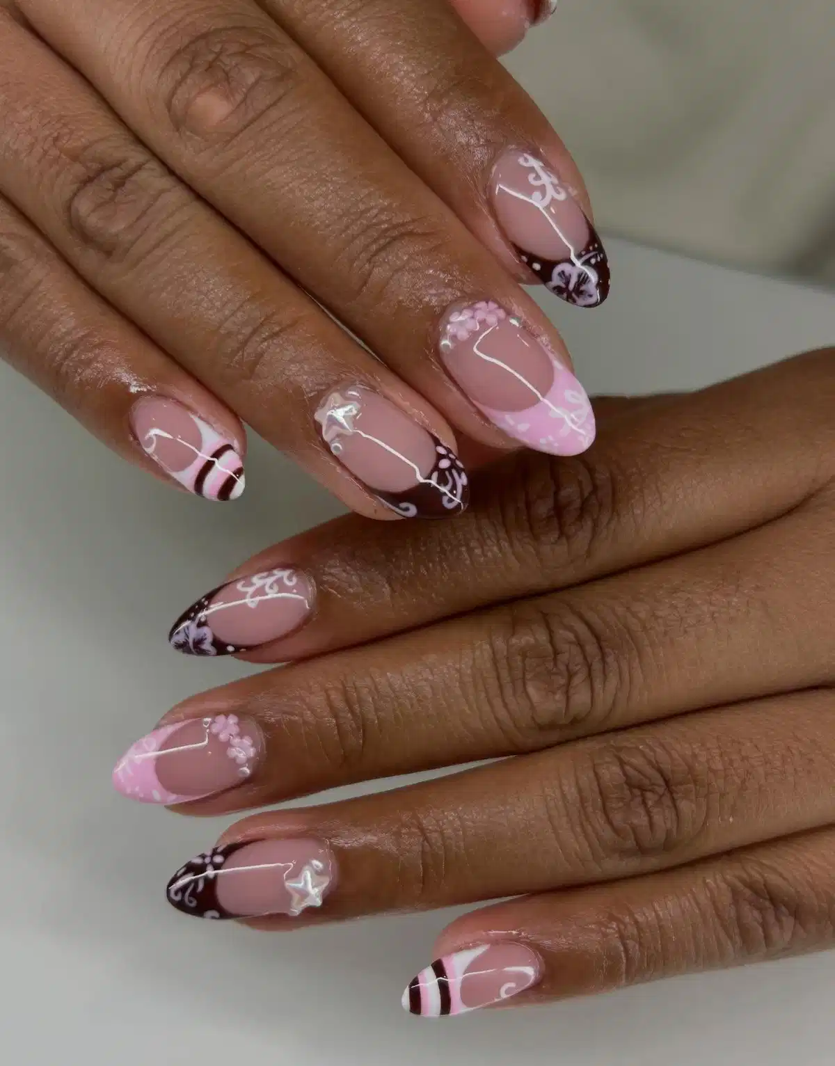 Nude-pink base with brown/pink tips and white linework