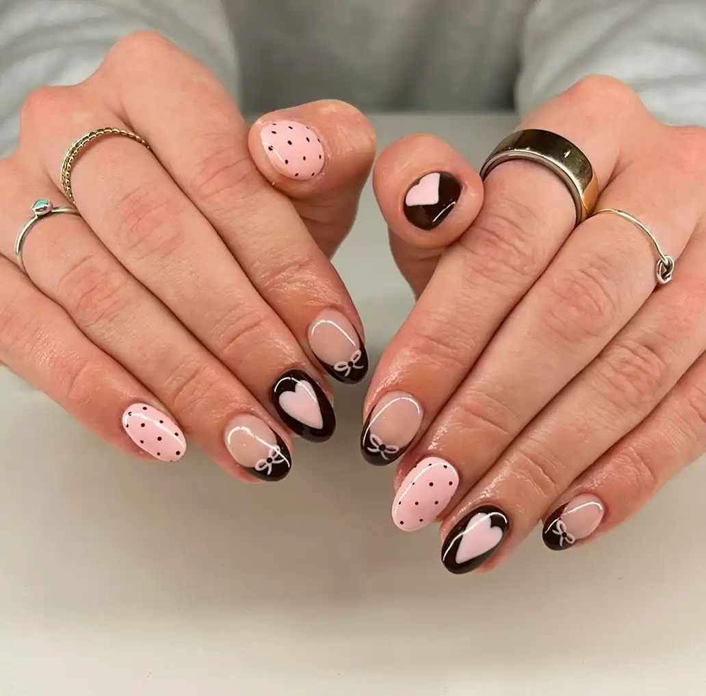 Brown French tips with pink hearts and dotted pink accents
