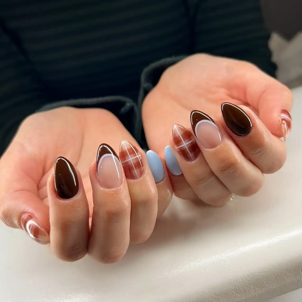 Outlined brown French tips with plaid and light-blue accent