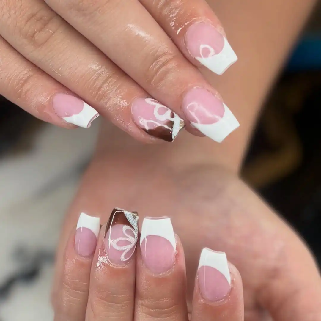 White French tips with a brown-and-silver swirl accent