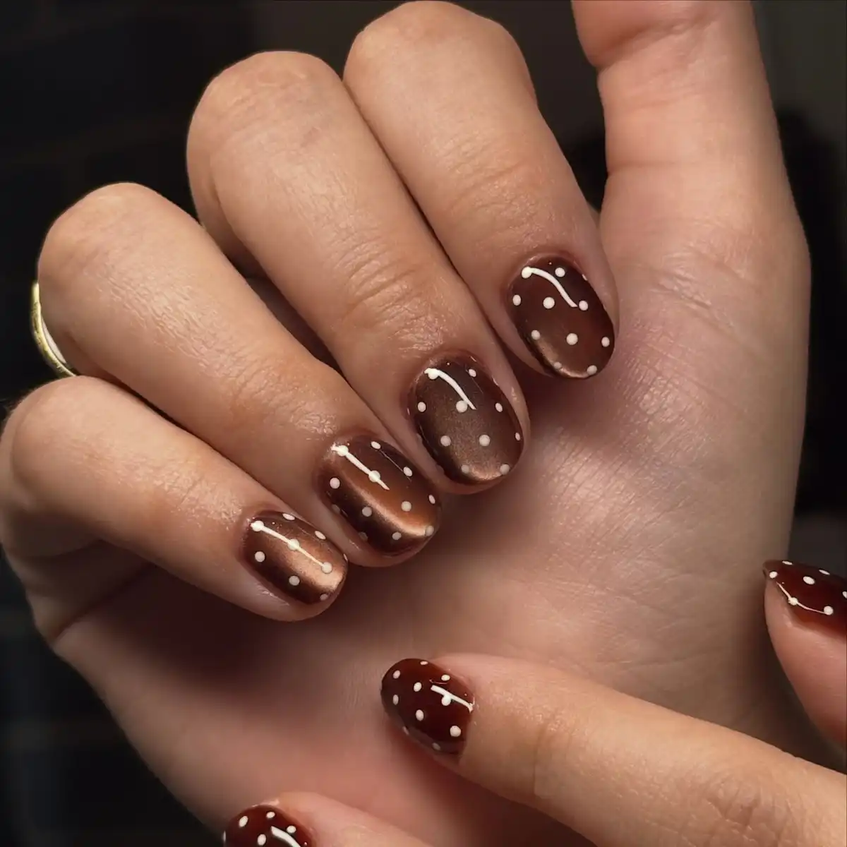 Glossy dark brown with white polka dots
